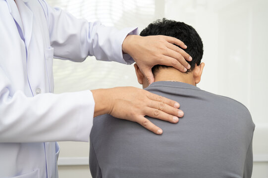 Physical therapy, Asian therapist doctor treat perform pain young man in hospital.