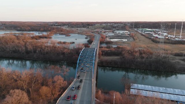 Aerial View Of Cars Crossing Bridge Over River In Suburban Illinois