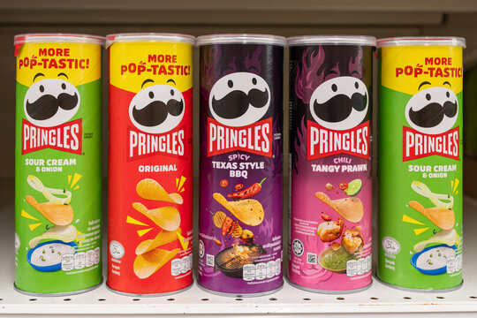 Variety of Pringles flavors displayed on a supermarket shelf