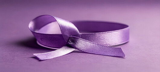 A purple ribbon lies on a solid purple background, tied in a bow