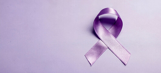 A purple ribbon symbolizing awareness and support for a cause on a light purple background