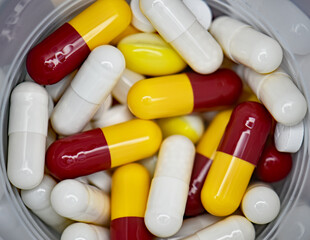 Large number of multi coloured pills, tablets or capsules. Prescription medicine, medication or drug misuse. Illness health treatment and cure  