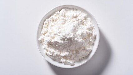A white bowl filled with flour on a clean white surface. Concept Culinary Still Life, Minimalist White, Flour in Bowl, Flat Lay Photography, Kitchen Studio Shot