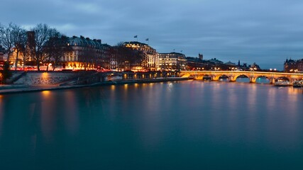 Bridge viev of Paris river during sunset, quiet evening , shimmering water and beutiful city landscape, sunset over Paris, warm sunset reflection 