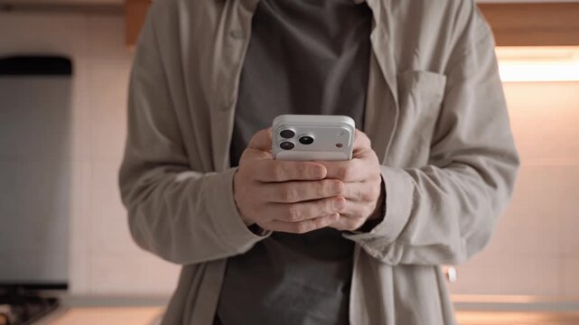 Man Using Apple iPhone 17 Pro Max Smartphone Indoors