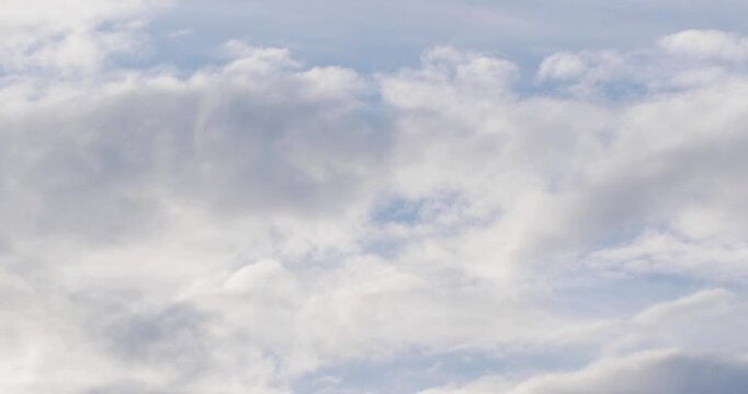 White cumulus clouds move across the blue sky. Sky timelapse video.