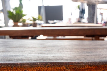 Wooden table surface with blurred background in warm interior