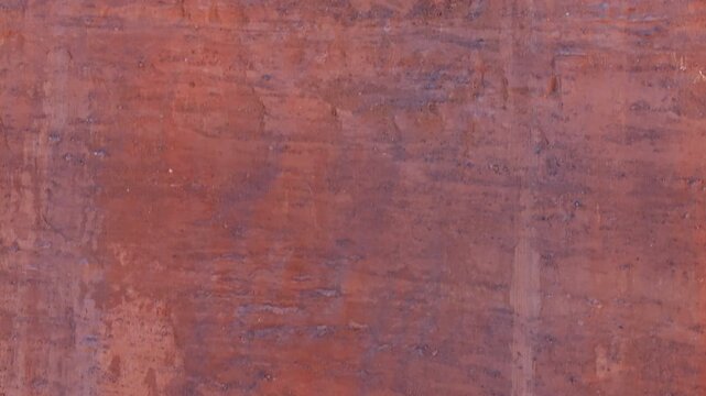 Ascending drone reveal shot of textured natural red sandstone surface. Closeup view turning into vast landscape view above.