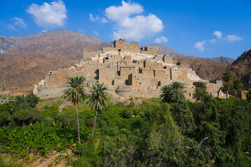 Fototapeta premium Thee Ain Heritage Village, the famous marble village of Al-Baha against a desert mountain backdrop in Saudi Arabia
