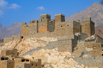 Thee Ain Heritage Village, the famous marble village of Al-Baha against a desert mountain backdrop in Saudi Arabia