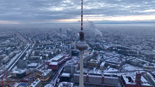 City of Berlin, Germany from above. Aerial winter cityscape view at sunrise or sunset, showing architectural landmarks Oberbaum Bridge, TV Tower and Berlin Cathedral in winter. 