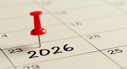 A Red Pushpin Pierces a Calendar, Highlighting the Year 2026 as a Significant Future Date.