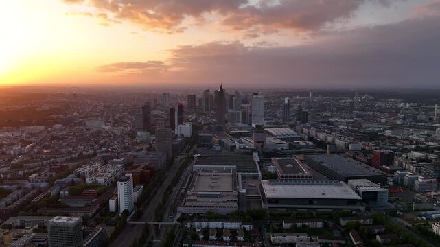 Descending dolly flight over a street in Frankfurt am Main, shrouded in morning autumn fog. Germany, Skyline, New skyscrapers City canyon in the light of sunset or sunrise. The shot has a continuation