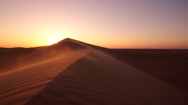 Dramatic desert sunset over rolling sand dunes golden light illuminates a vast landscape creating an awe-inspiring scene of natural beauty and tranquility