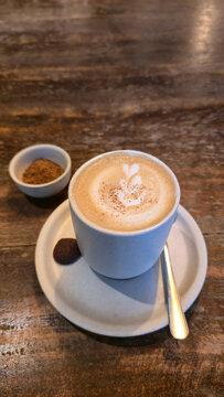 Cozy wooden table scene featuring latte with heart foam and warm ambiance Bali Ubud