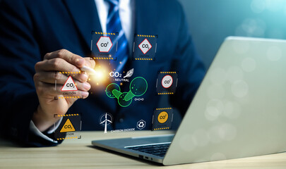 Businessman analyzing CO2 emission and carbon neutral concept on digital interface. Climate change...