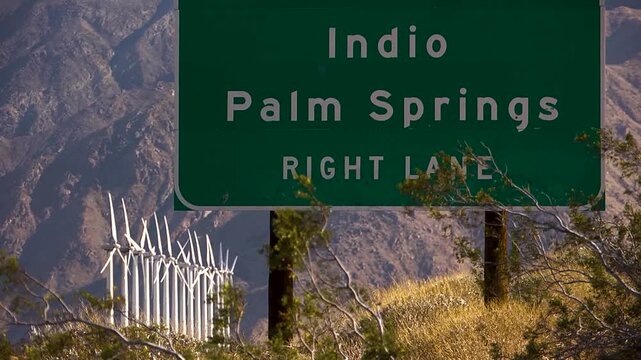 Palm springs freeway sign with windmills in the background