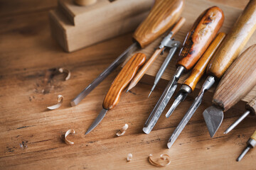 Woodworking tools on wooden workbench in carpentry workshop. Joinery and craft carving tools for wood processing.