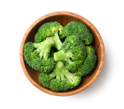 Fresh broccoli in wooden bowl isolared on white.