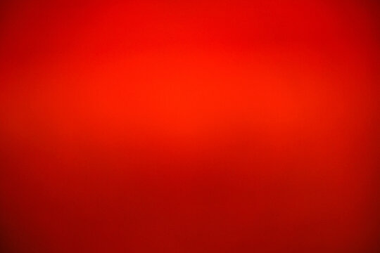 Abstract luxury red gradient background. Vibrant scarlet blurred texture for Christmas, Valentine's Day, or Chinese New Year. Elegant smooth crimson backdrop for banner, poster, and presentation
