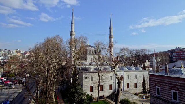 Aerial footage of the historic Yeni Valide Mosque located in &Uuml;sk&uuml;dar, Istanbul. Ottoman architecture, domes and minarets blend beautifully with the surrounding urban landscape.