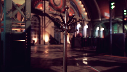 A vintage coat rack is positioned at the forefront of a spacious hall. The warm lights illuminate the architectural details while shadows create an inviting atmosphere, echoing stories of the past.