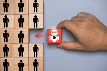 Artificial intelligence replacing human workforce concept. Wooden blocks with people icons and red AI robot block being selected. Automation, digital transformation, job disruption and technology.