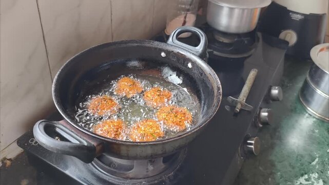 Handmade Lentil Fritters Dal Wada Being Fried in Hot Oil Using Traditional Kadai