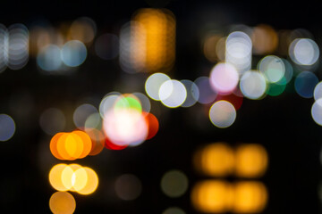 Obraz premium Abstract colorful night city lights bokeh background with copy space