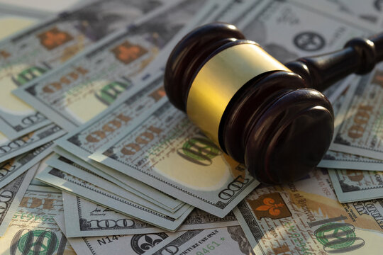 One Hundred Dollars banknotes and wooden gavel close-up