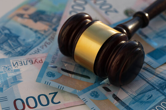 Two thousan rubles banknotes and wooden gavel close-up