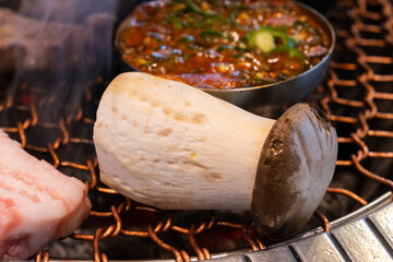 various foods on the charcoal BBQ grill