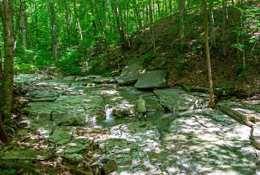 Camouflaged man by cascade