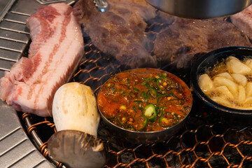 various foods on the charcoal BBQ grill