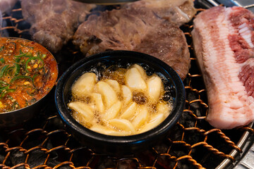 various foods on the charcoal BBQ grill