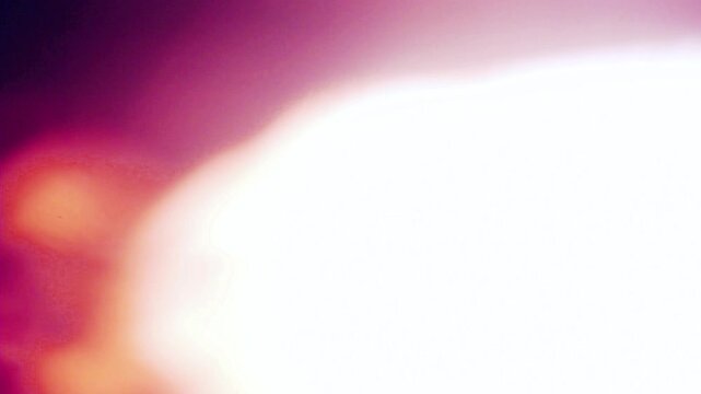 film burn transition with vibrant purple and orange light flares with a bright white bleed. This video effect is perfect for adding a cinematic feel or a quick edit to your footage.