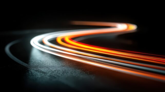 Curving red, orange, and white light trails sweep across a dark asphalt road at night, captured with long exposure to emphasize motion, speed, and abstract urban energy.