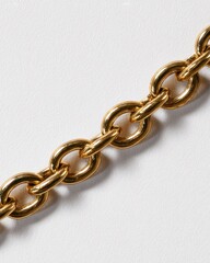 Fototapeta premium Close-up of a golden chain resting diagonally against a plain white background