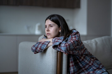 Bored frustrated teen girl feeling no motivation, lack of dopamine sitting alone on couch sadly...