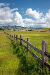 Rural field scene with rustic fencing, green meadow, and expansive open sky