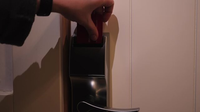 Guest is opening a hotel room door with an electronic key card. Security and protection system concept. High quality 4k footage