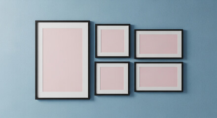 Fototapeta premium Gallery Wall Display with Five Black Framed Pictures and Pink Mattes on a Textured Blue Background, Perfect for Mockups and Art Concepts