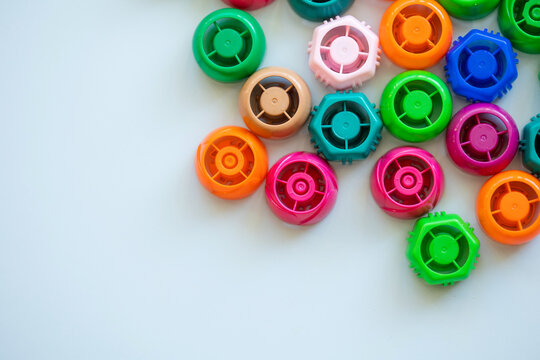 recycling of plastic. colorful lids caps. collected recyclables on blue background with copy space