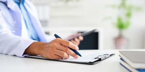  closeup Hand Writing, book and notebook by doctor or healthcare professional with a prescription...