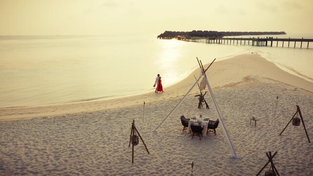 Romantic couple's luxury escape at a tropical beach resort during sunset