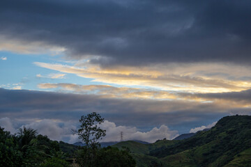 Fototapeta premium Late afternoon landscape with cloudy skies over mountains in the western region of Rio de Janeiro, Brazil.