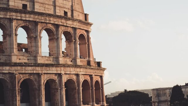 Majestic exterior of the Colosseum in Rome, Italy, revealing the Arch of Constantine and the crowd of tourists below, a renowned UNESCO World Heritage Site and ancient amphitheater