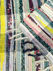 Colorful woven fabric showing intricate patterns and textures on a flat surface in bright daylight