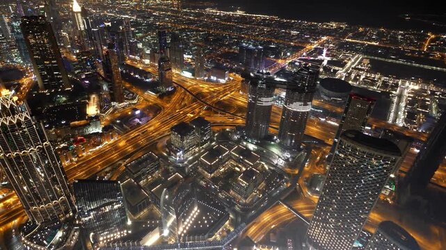 Aerial view of Dubai city skyline and highways at night, USA Vs Iran war time. 