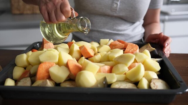 Young Woman Pours Oil And Seasons Vegetables For Oven Baking
